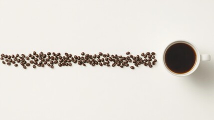 Naklejka premium Coffee beans lined up next to a cup of coffee on white background