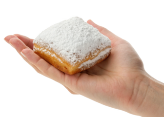 hand holding Beignet isolated on a transparent background.