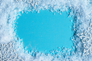 Blue snowy christmas background with snowflakes. Christmas greeting card. Space for text.