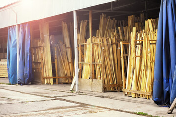 Stack of fresh pine boards in a sawmill warehouse. Harvesting, sale of lumber for construction