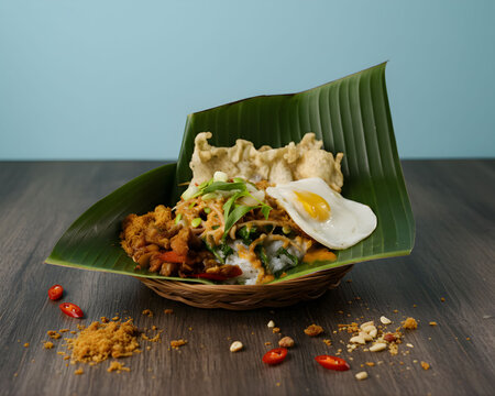 Indonesian Pecel Pincuk Rice with fried egg side dish