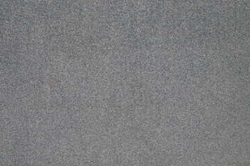 Closeup texture of wet beach sand with fine grains
