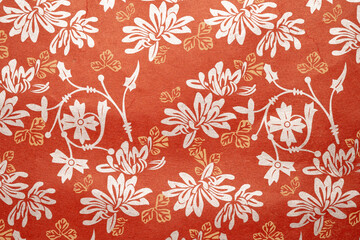 Vintage floral pattern on textured red background
