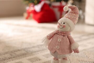 Cute snowman figure indoors, closeup with space for text. Merry Christmas and Happy New Year