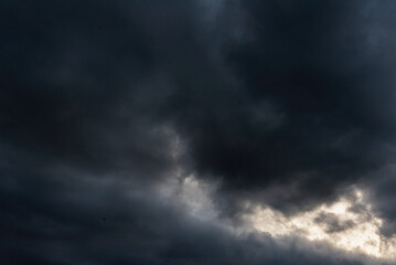 Dramatic dark storm thundercloud rain clouds on black sky background. Dark thunderstorm clouds rainny landscape. Meteorology danger windstorm disaster climate. Dark cloudscape storm disaster gray sky