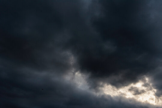 Dramatic dark storm thundercloud rain clouds on black sky background. Dark thunderstorm clouds rainny landscape. Meteorology danger windstorm disaster climate. Dark cloudscape storm disaster gray sky