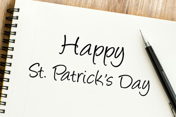 Handwritten festive greeting on a white notepad, celebrating a St Patricks Day