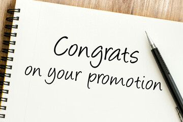 Congrats on your promotion message handwritten on a spiral notebook, symbolizing career advancement and professional success