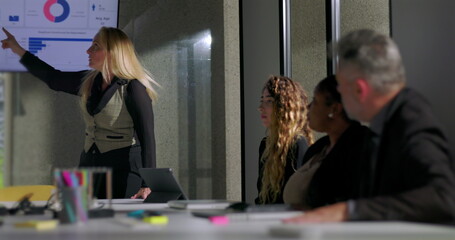 Female boss scolds employee for checking phone during presentation in tense office meeting, asserting authority and addressing disrespectful behavior in corporate setting
