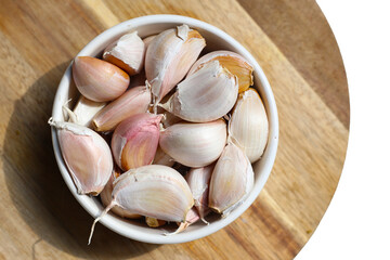 Garlic cloves on wooden cutting board