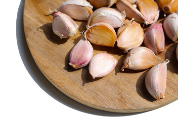 Garlic cloves on wooden cutting board