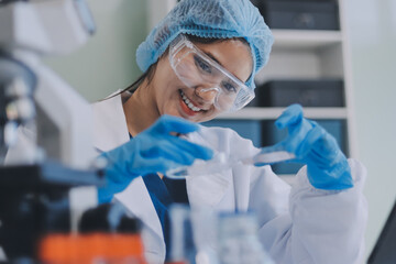 Portrait, science and happy woman on laptop in lab to research chemistry, test or innovation....
