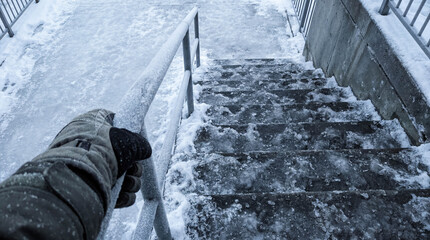 Icy stairs covered in snow dangerous descent winter hazard slippery steps caution risk falling safety handrail outdoor building entrance public space frozen surface accident prevention careful walking