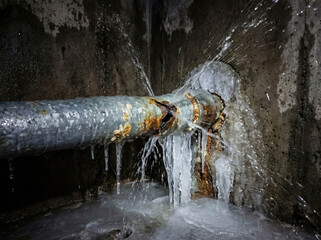 Burst water pipe frozen plumbing winter damage leak flood emergency repair basement house maintenance cold weather disaster metal crack flowing water mess plumber needed construction home problem 