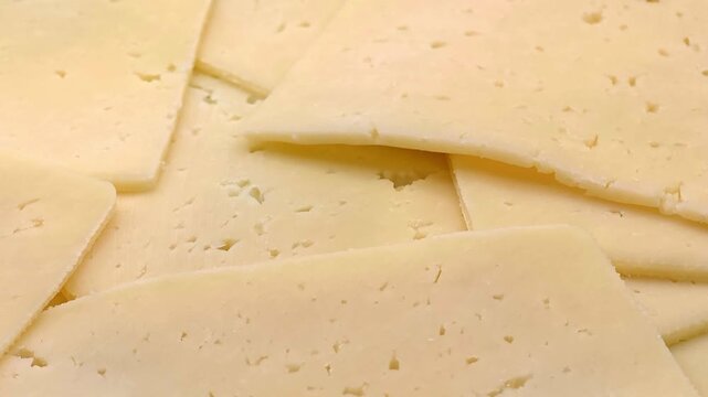 Slices of tasty fresh yellow cheese, dairy product, breakfast ingredient