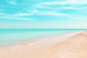 Dreamy turquoise ocean and sandy beach under a clear summer sky