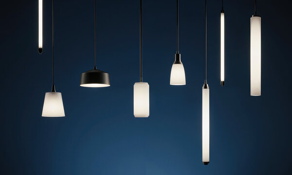 Sculptural Lighting Display. A dark studio where a collection of minimalist pendant lights hang at different heights, all turned off.