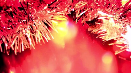 Festive bright red and gold tinsel garland glittering with holiday cheer, perfect for Christmas promotions and seasonal greetings