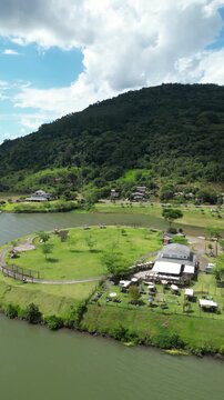 Aerial View of the Goio-&Ecirc;n Recreation Area with Lake, Mountains and Buildings on a Sunny Day
