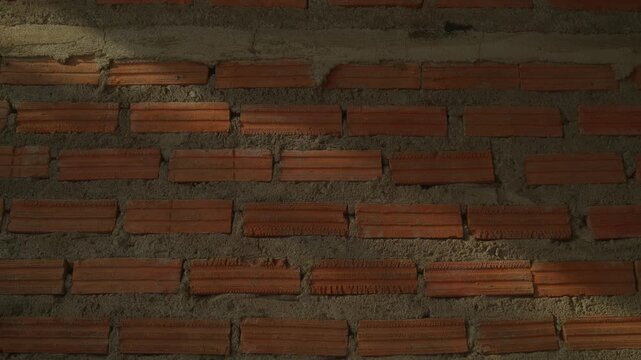 Detailed static shot of a red brick wall surface, ideal for backgrounds, architectural textures, and construction concepts.