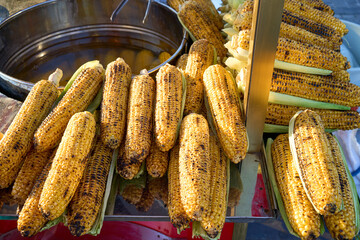 Grilled corn on the cob, a popular street food. Freshly cooked and ready to eat.