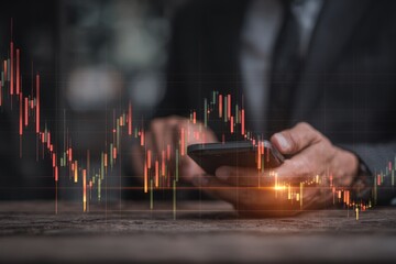 Businessman using smartphone with overlay of stock market candlestick chart.