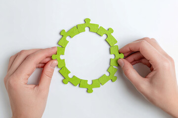 Circular puzzle pieces symbolize concept of circular economy in business with hands assembling green jigsaw on white background representing sustainability and innovation