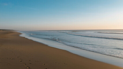 Obraz premium Beach with gentle waves and footprints