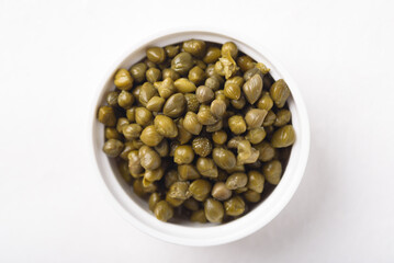 Pickled capers on white background. Healthy food ingredient