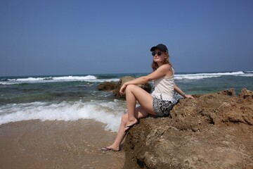Happy Young Woman Exploring the Rocky Mediterranean Coast in Summer