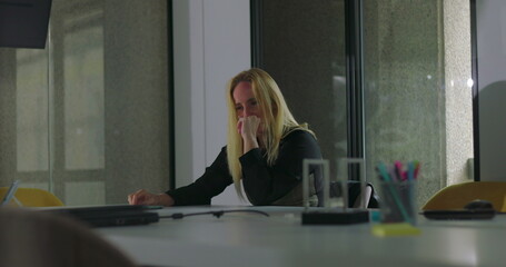 Enraged businesswoman slams both fists on conference table in outburst of anger, head down with...