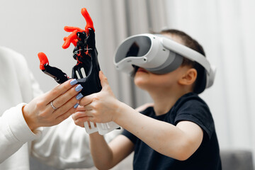 Young caucasian male using vr headset and toy robotic arm made by 3D printer for tech exploration