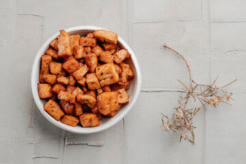 high angle view of a bowl of marinated tofu cubes