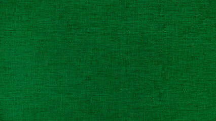 Green linen fabric texture background. High resolution close up of natural woven textile surface. Green canvas material pattern for abstract wallpaper or furniture upholstery design.