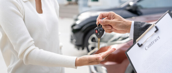 Fototapeta premium lease, rental car, sell, buy. happy pass on key for new owner. Sales, loan credit financial, rent vehicle, insurance, renting, Seller, dealer, installment, car care business