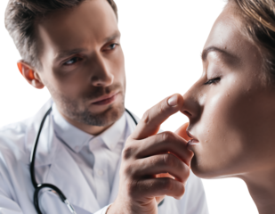 Plastic surgeon examining female patients nose isolated on transparent background