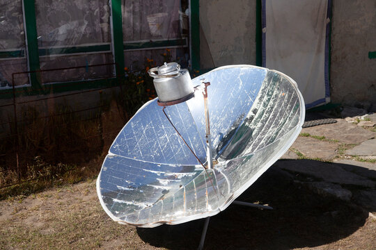 Warming the teapot in a solar cooker. Ecology concept. Renewable green energy. Nepal. Himalaya