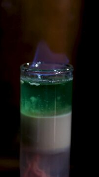Nifty visuals of a B52 cocktail being made in a lively night bar scene. High quality 4k footage