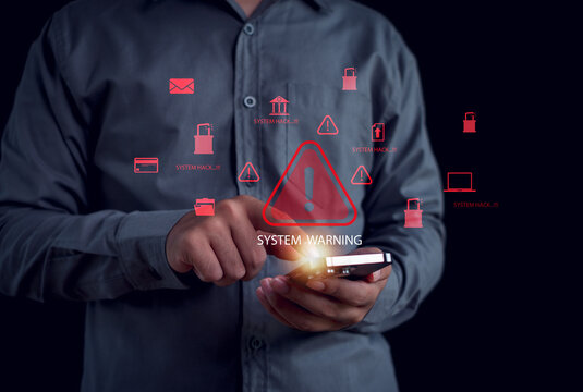 holding smartphone with digital system warning icons, representing cybersecurity alerts, data breach threats, hacking risks, online security issues, the importance of protecting digital information.