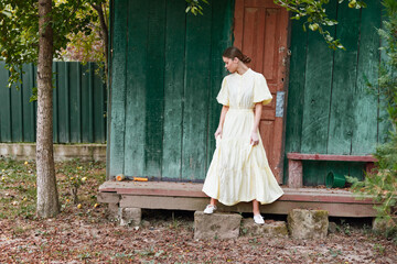 woman dress porch rustic cottage outdoors standing contemplative authentic inclusive portrait of a...