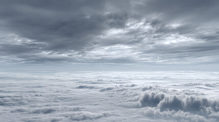 Obraz premium A vast expanse of clouds dominates the view, with layers of fluffy, white clouds filling the lower portion of the frame, and a darker, more ominous layer of clouds above.