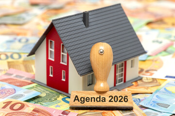 Ein Holzstempel ist beschriftet mit dem Aufdruck Agenda 2026 als Symbolbild für anstehende...