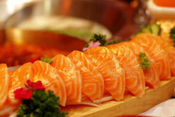 Several pieces of salmon sushi arranged as a set meal in a restaurant