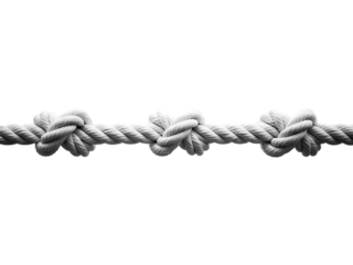 Close up of a thick white rope with multiple decorative knots on a black background