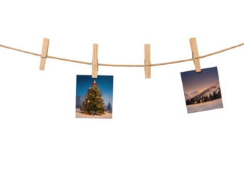 Christmas tree and mountain polaroid photos pinned to clothesline rope, isolated on a transparent background