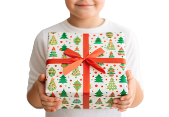 Child holding wrapped Christmas present with colorful tree patterns, isolated on a transparent background