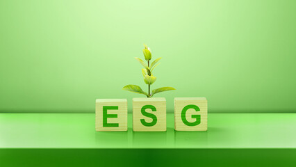 Green leaves and wooden cubes with ESG text on a green background. Concept of ESG (Environmental, Social, and Governance)