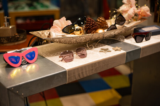 Zurich, Switzerland, November 26 2025. Gucci store window display with assortment of stylish sunglasses. Close up shot, night time, artificial illumination, no people