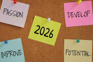 5 post-it paper pin on board with number 2026 in the middle and word passion, develop, improve, potential around. new year goal target for work with passion concept