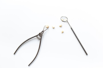 Teeth crows for implantation with dental tooth extraction forceps on white background. Professional...